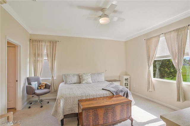 bedroom featuring a ceiling fan, crown molding, carpet, and baseboards