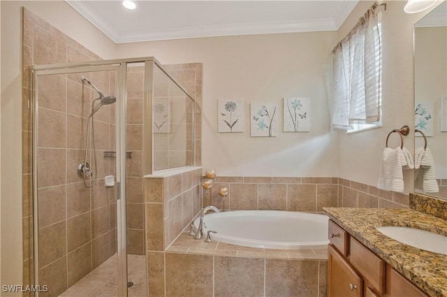 full bathroom with vanity, a garden tub, a shower stall, and crown molding