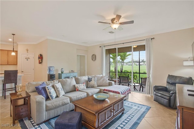 living area featuring light tile patterned floors, visible vents, a ceiling fan, and ornamental molding