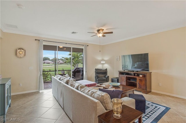 living area featuring visible vents, crown molding, baseboards, light tile patterned flooring, and a ceiling fan