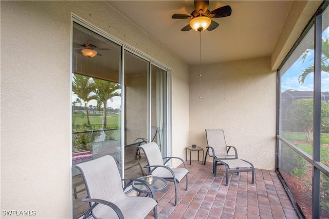 sunroom / solarium with a ceiling fan