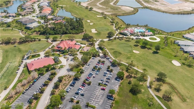 birds eye view of property featuring golf course view and a water view