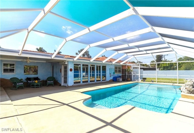 view of swimming pool with a patio, fence, a fenced in pool, and a lanai