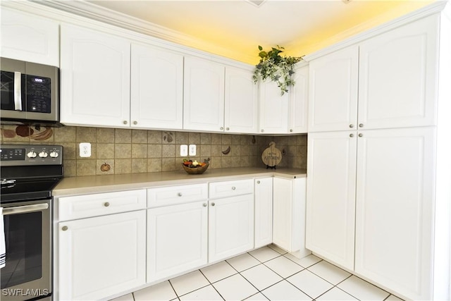 kitchen with appliances with stainless steel finishes, white cabinets, backsplash, and light countertops