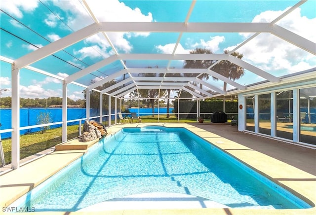 view of swimming pool with a water view, a patio area, glass enclosure, and a fenced in pool