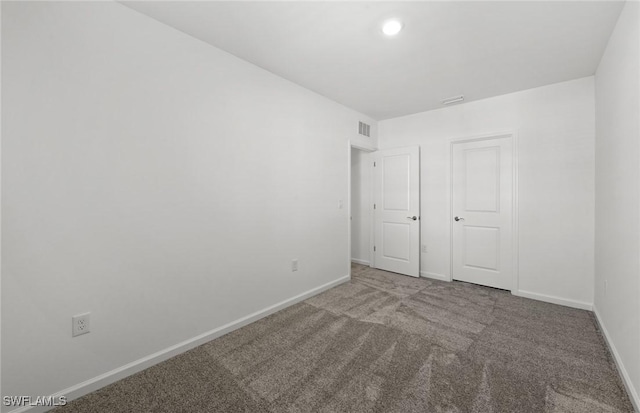 unfurnished bedroom with carpet floors, recessed lighting, visible vents, and baseboards