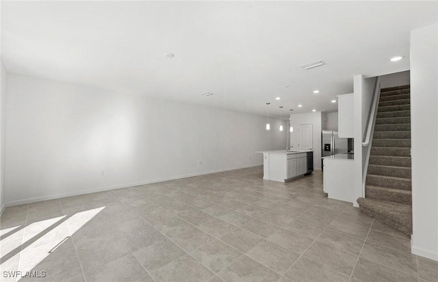 unfurnished living room with light tile patterned floors, stairs, baseboards, and recessed lighting