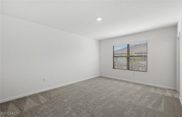 spare room with carpet and baseboards