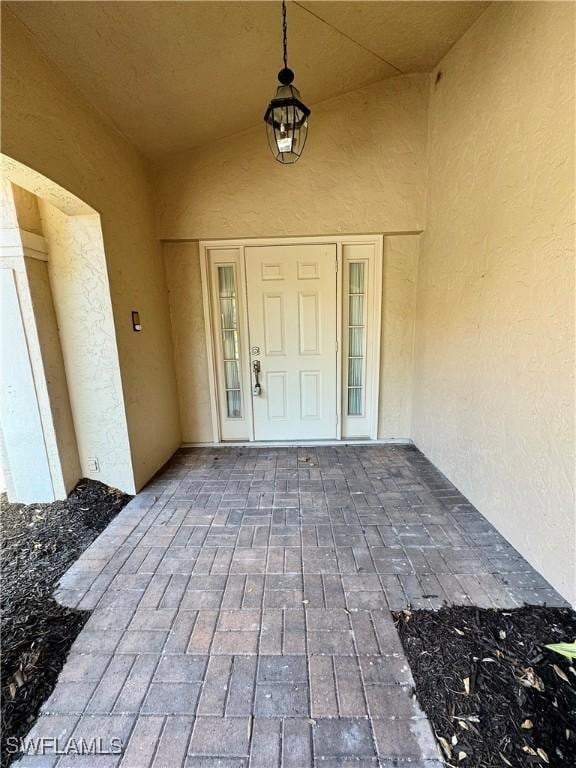 entrance to property with stucco siding