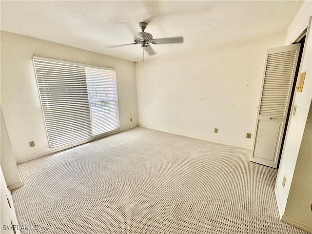 unfurnished bedroom with carpet flooring and a ceiling fan