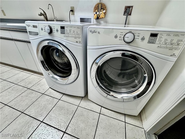 laundry area with light tile patterned flooring, laundry area, and washer and dryer