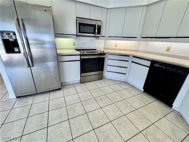 kitchen with light tile patterned floors, stainless steel appliances, and light countertops