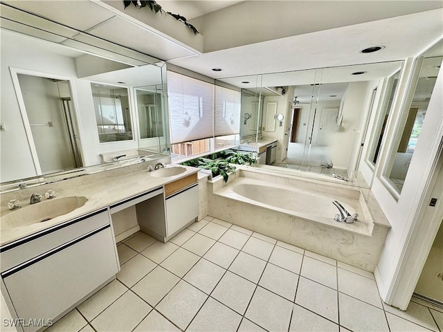 bathroom featuring a sink, a garden tub, double vanity, and tile patterned floors