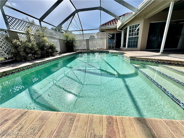 view of pool featuring a fenced in pool, a patio, and glass enclosure