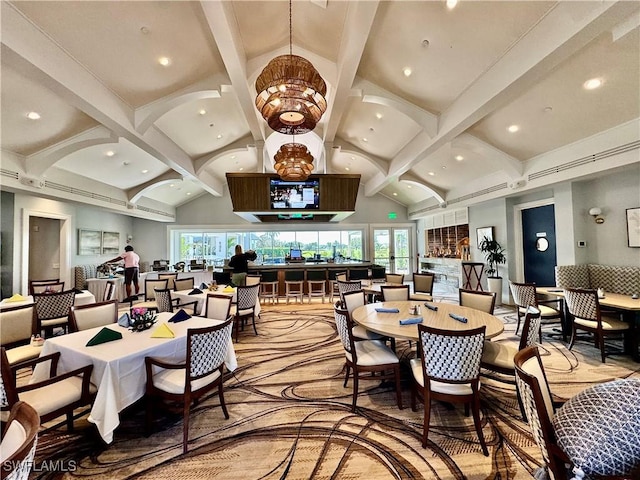 dining space featuring plenty of natural light, high vaulted ceiling, and beam ceiling