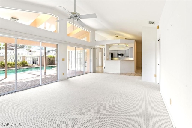 11730 Quail Village Way Unit 103-1, Naples, FL 34119 - unfurnished living room with lofted ceiling, light colored carpet, and a ceiling fan