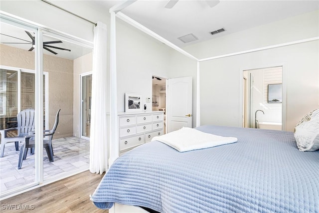 bedroom with ensuite bathroom, wood finished floors, visible vents, and a ceiling fan