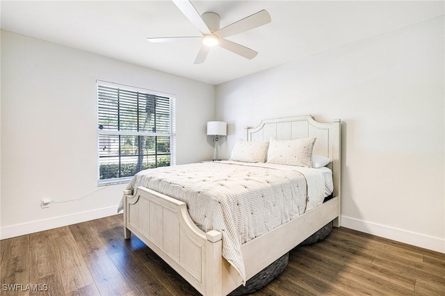 bedroom featuring baseboards, dark wood finished floors, and a ceiling fan