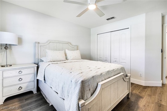 bedroom featuring a closet, visible vents, dark wood-type flooring, a ceiling fan, and baseboards