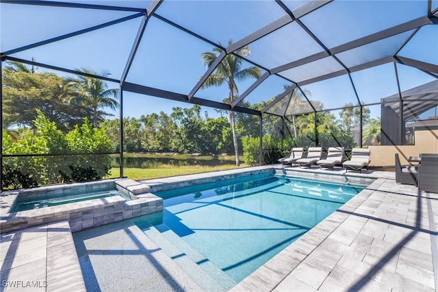 view of pool featuring glass enclosure, a pool with connected hot tub, and a patio area