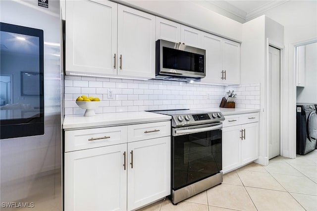 kitchen with stainless steel appliances, light countertops, and white cabinetry