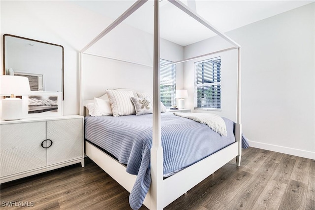 bedroom with baseboards and wood finished floors