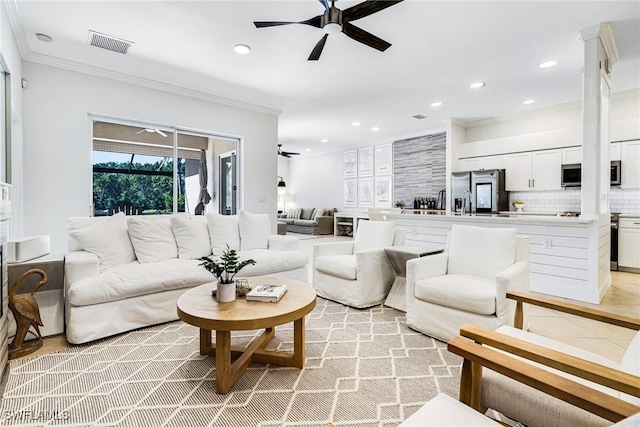 living area featuring recessed lighting, visible vents, and ornamental molding