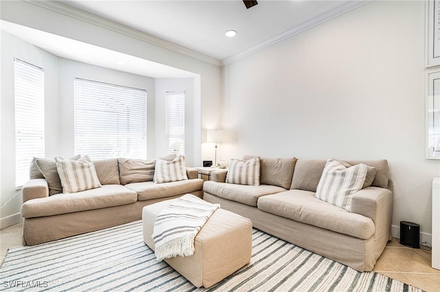 living room with plenty of natural light, crown molding, and baseboards