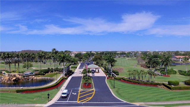 aerial view featuring golf course view and a water view