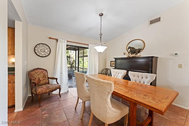 dining room with vaulted ceiling, baseboards, visible vents, and tile patterned floors