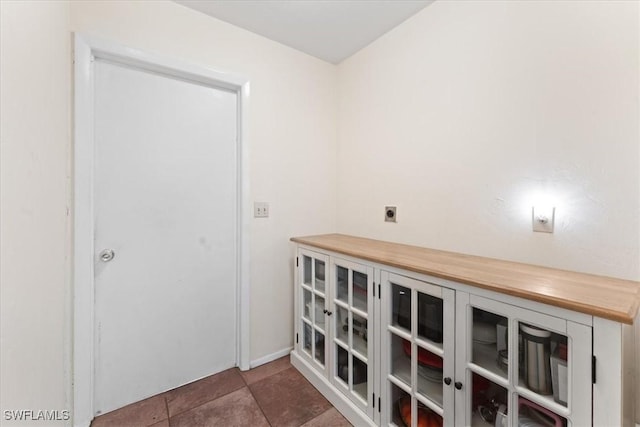 laundry room featuring electric dryer hookup and tile patterned floors