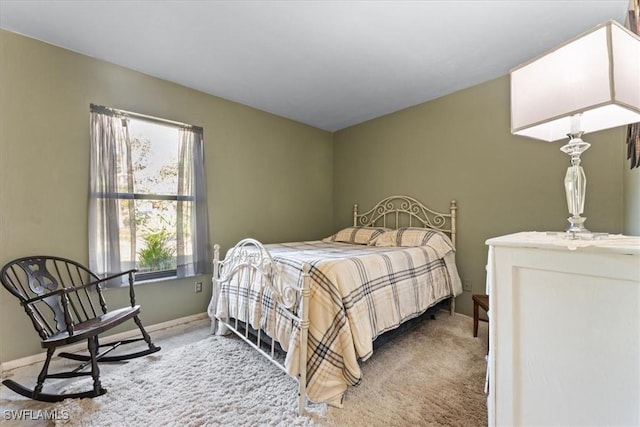 carpeted bedroom featuring baseboards