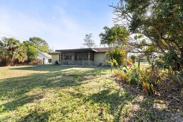 view of yard with fence and a sunroom