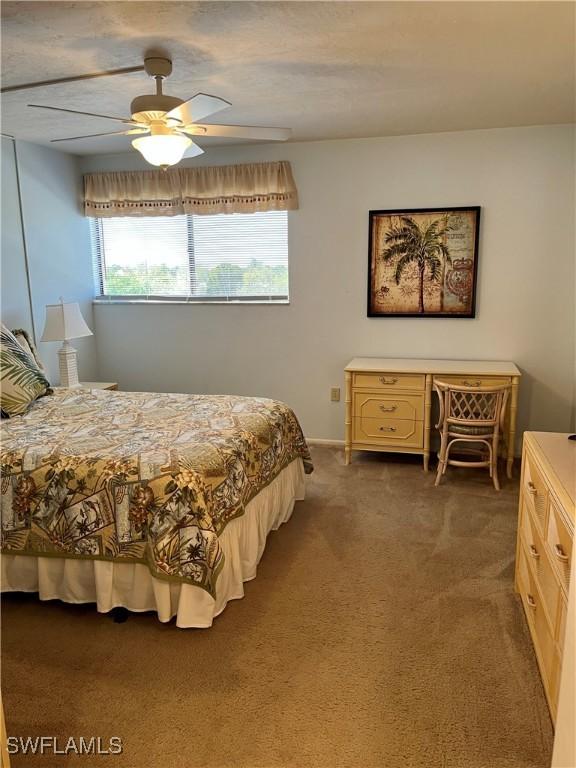 carpeted bedroom with a ceiling fan