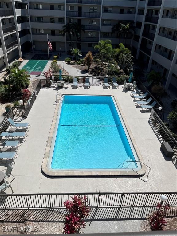 pool featuring a patio area and fence