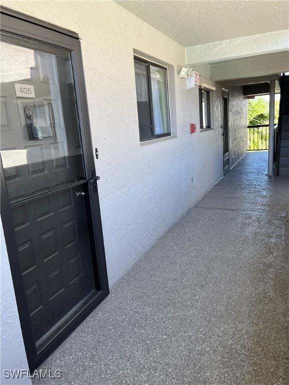 property entrance with stucco siding