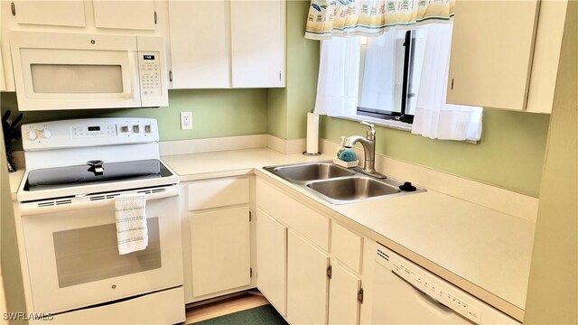2121 Collier Ave Unit 405, Fort Myers, FL 33901 - kitchen featuring light countertops, a sink, and white appliances
