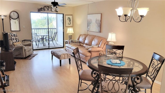 2121 Collier Ave Unit 405, Fort Myers, FL 33901 - dining area featuring ceiling fan with notable chandelier, light wood-type flooring, and baseboards