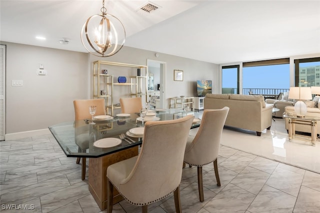 dining area with a notable chandelier, visible vents, marble finish floor, and baseboards