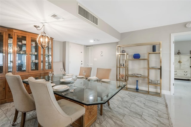 dining area featuring visible vents, marble finish floor, baseboards, and an inviting chandelier