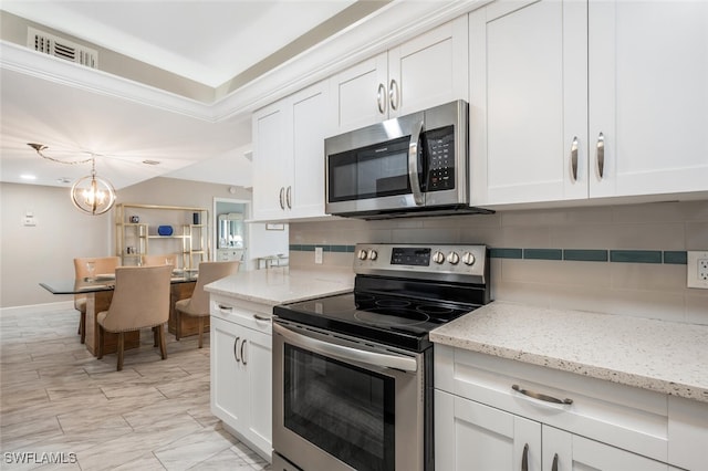 kitchen featuring tasteful backsplash, visible vents, appliances with stainless steel finishes, and white cabinetry