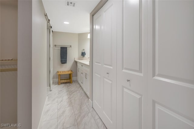 bathroom featuring visible vents, marble finish floor, recessed lighting, baseboards, and vanity