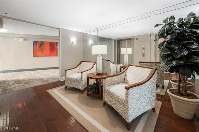 sitting room featuring baseboards and hardwood / wood-style floors