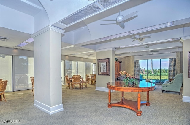 interior space with visible vents, carpet flooring, baseboards, ceiling fan, and ornate columns