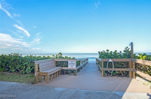 view of property's community featuring a deck with water view