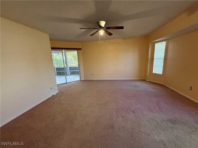 empty room featuring ceiling fan, carpet flooring, and baseboards