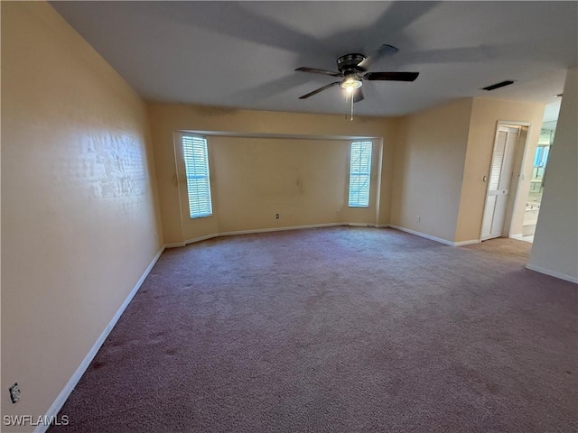 spare room with a ceiling fan, baseboards, visible vents, and carpet flooring