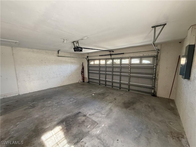 garage featuring electric panel and a garage door opener