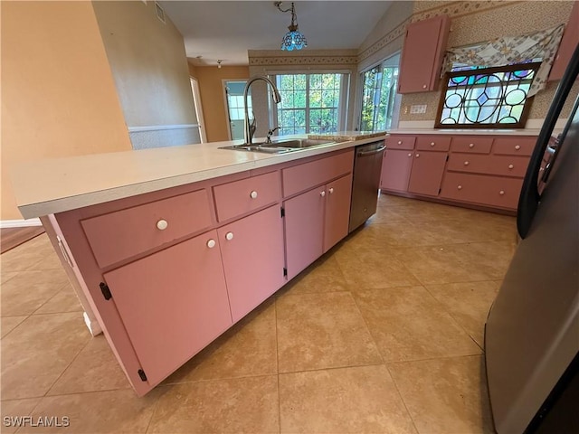 kitchen featuring light countertops, stainless steel dishwasher, fridge, a sink, and light tile patterned flooring