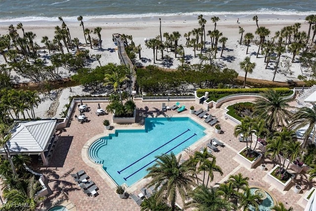 community pool featuring a water view and a view of the beach